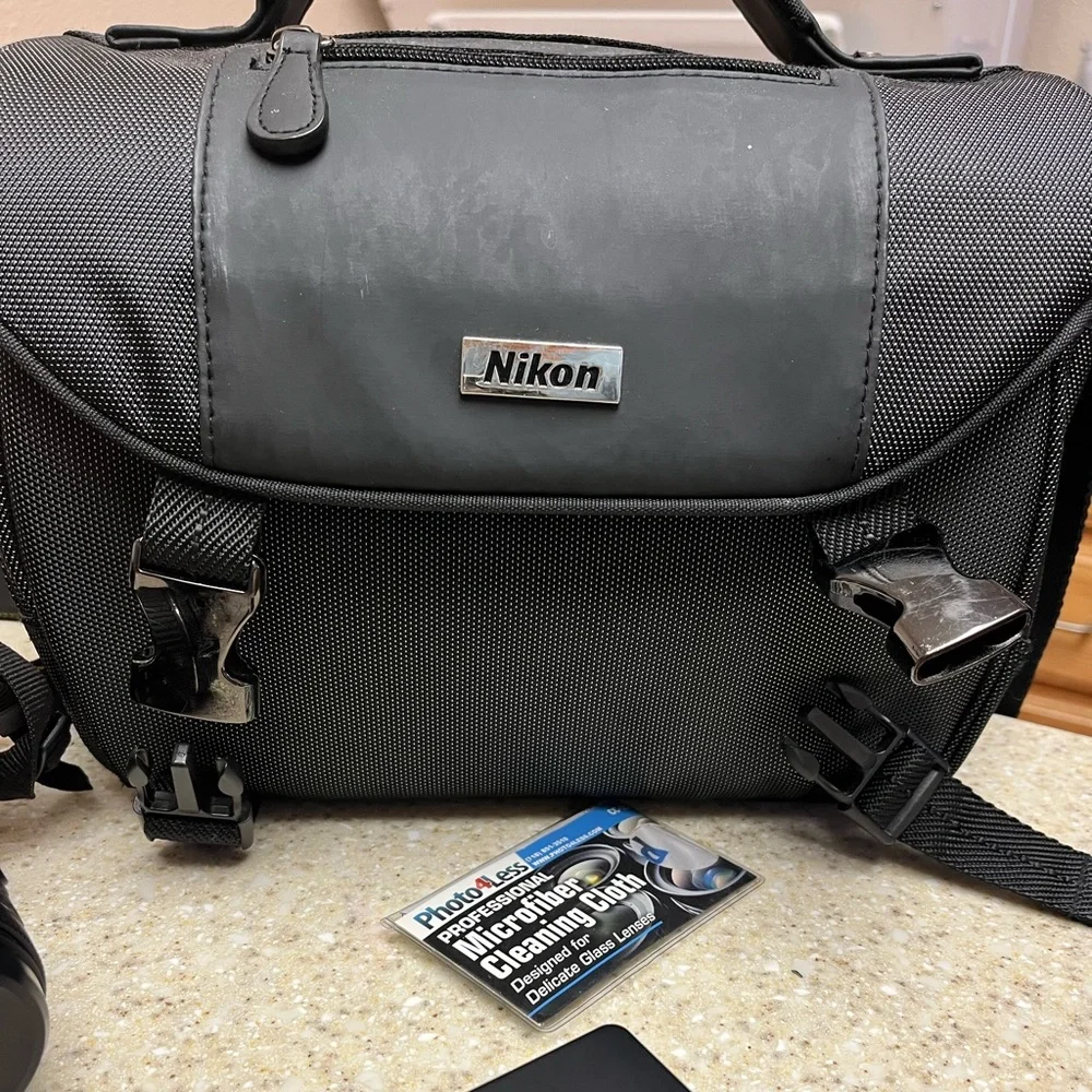 Nikon D3400 DSLR Camera with two lenses, 2 batteries, battery charger, and bag